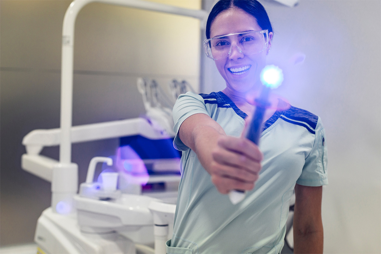 Dental professional demonstrating modern clinical technology