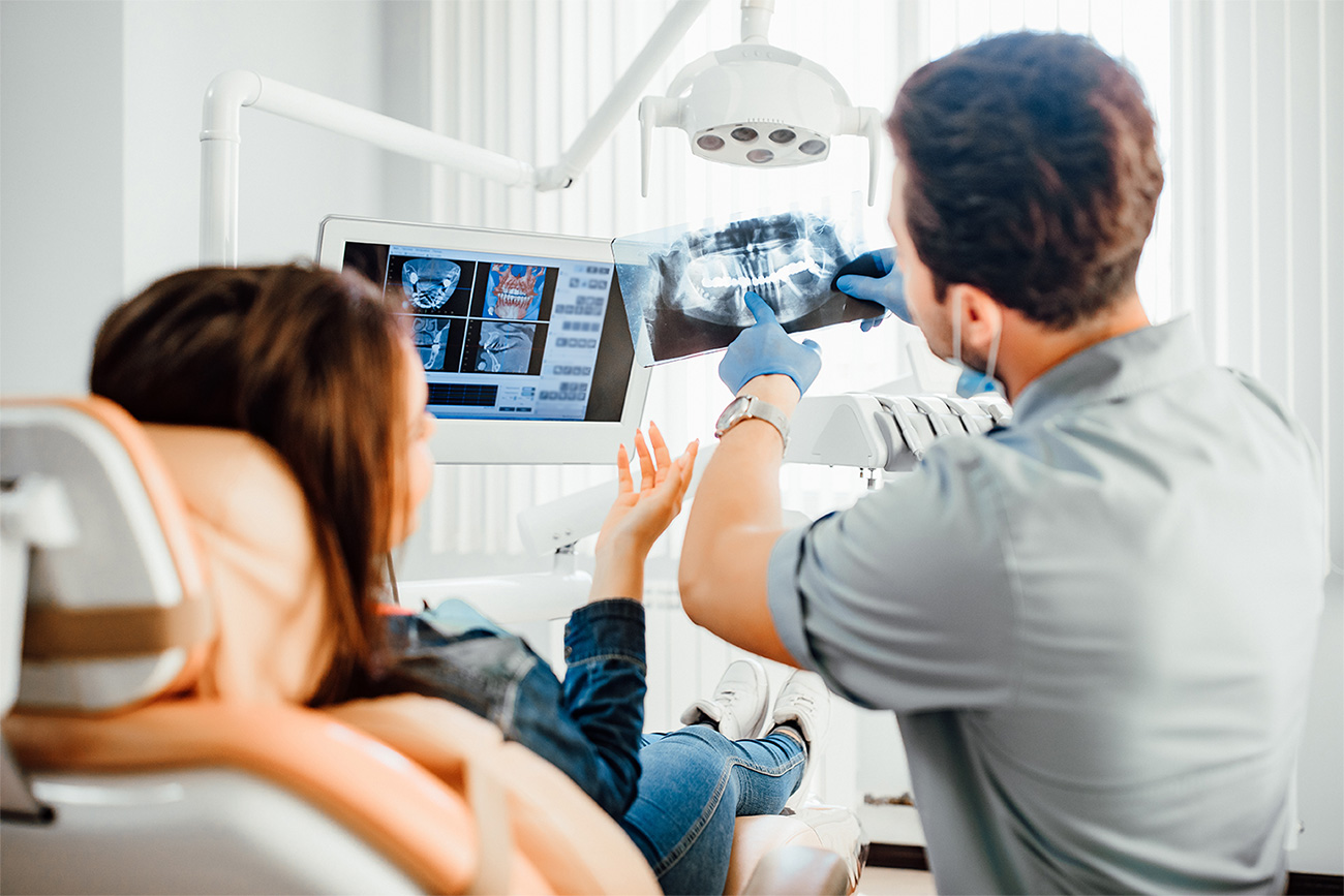 Dentist explaining diagnostic images to a patient