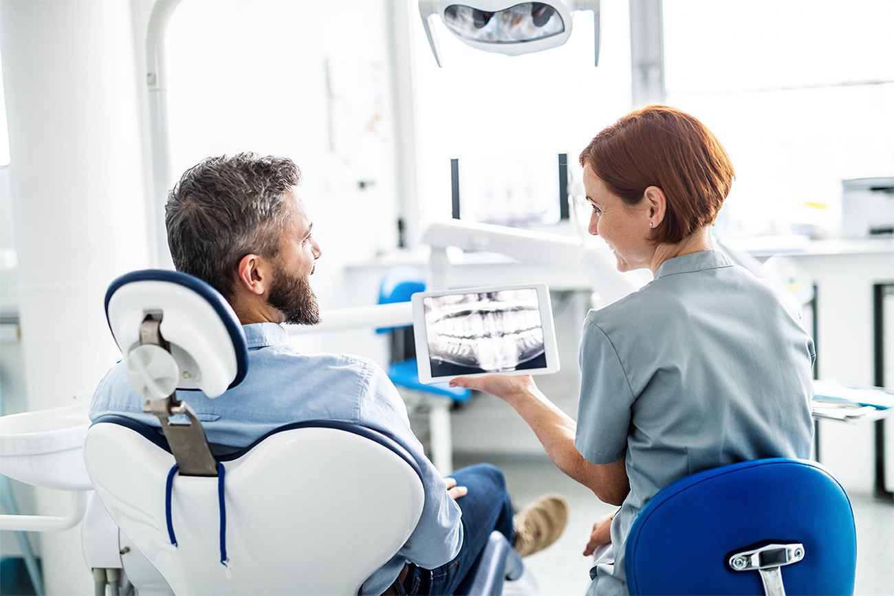Dentist reviewing dental images with a patient