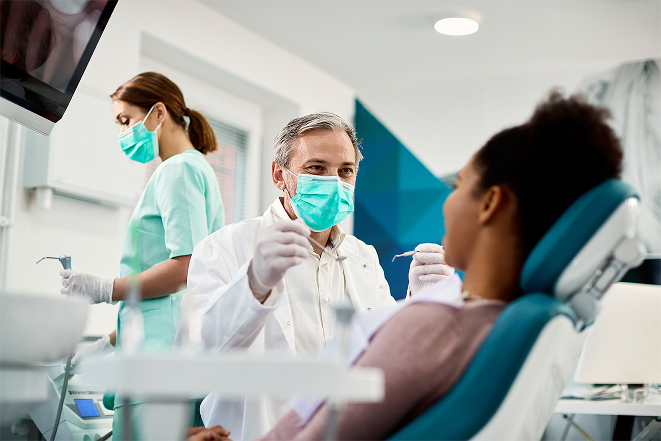 Dental professionals consulting with a patient