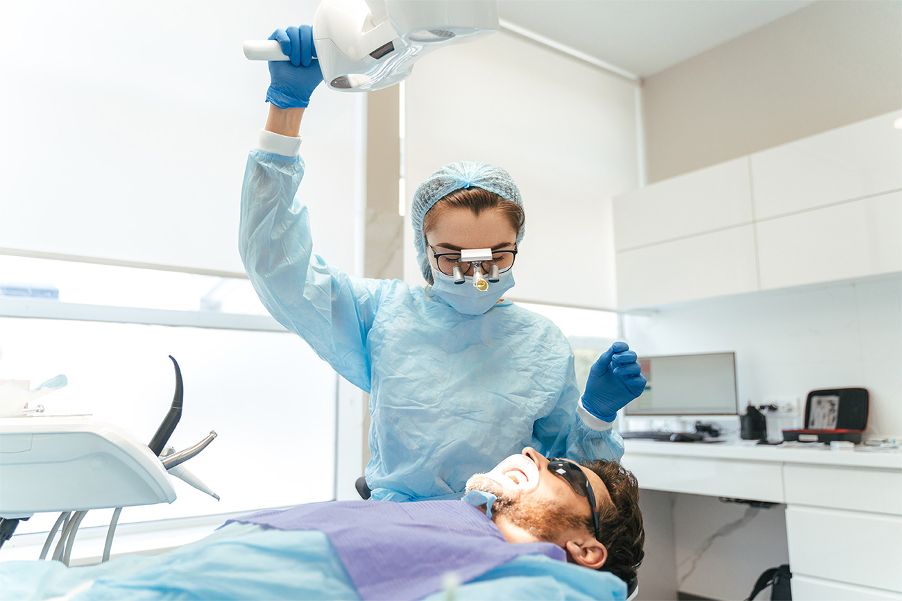 Dentist providing treatment in a bright modern operatory